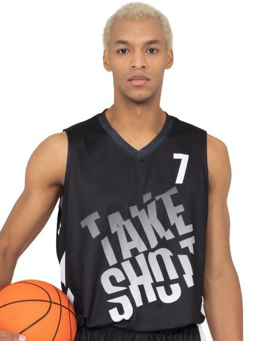 A man with a black shirt on a basketball ground holding a basketball.
